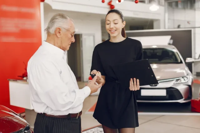 An elderly person buying a car in Japan