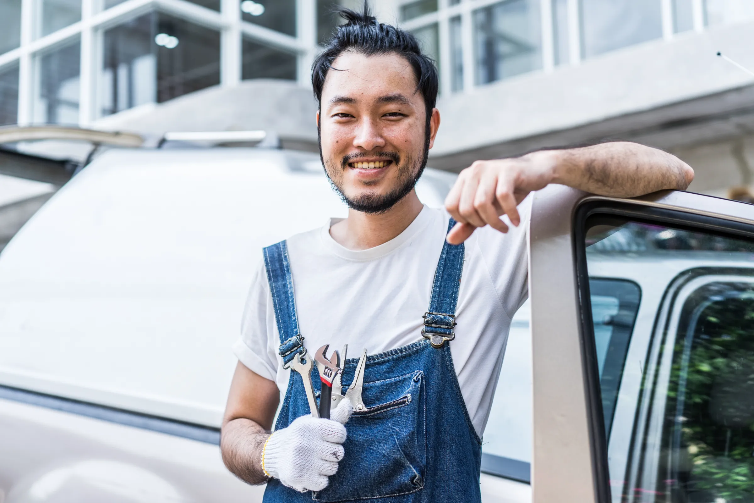 service page about us image a man standing outside a car