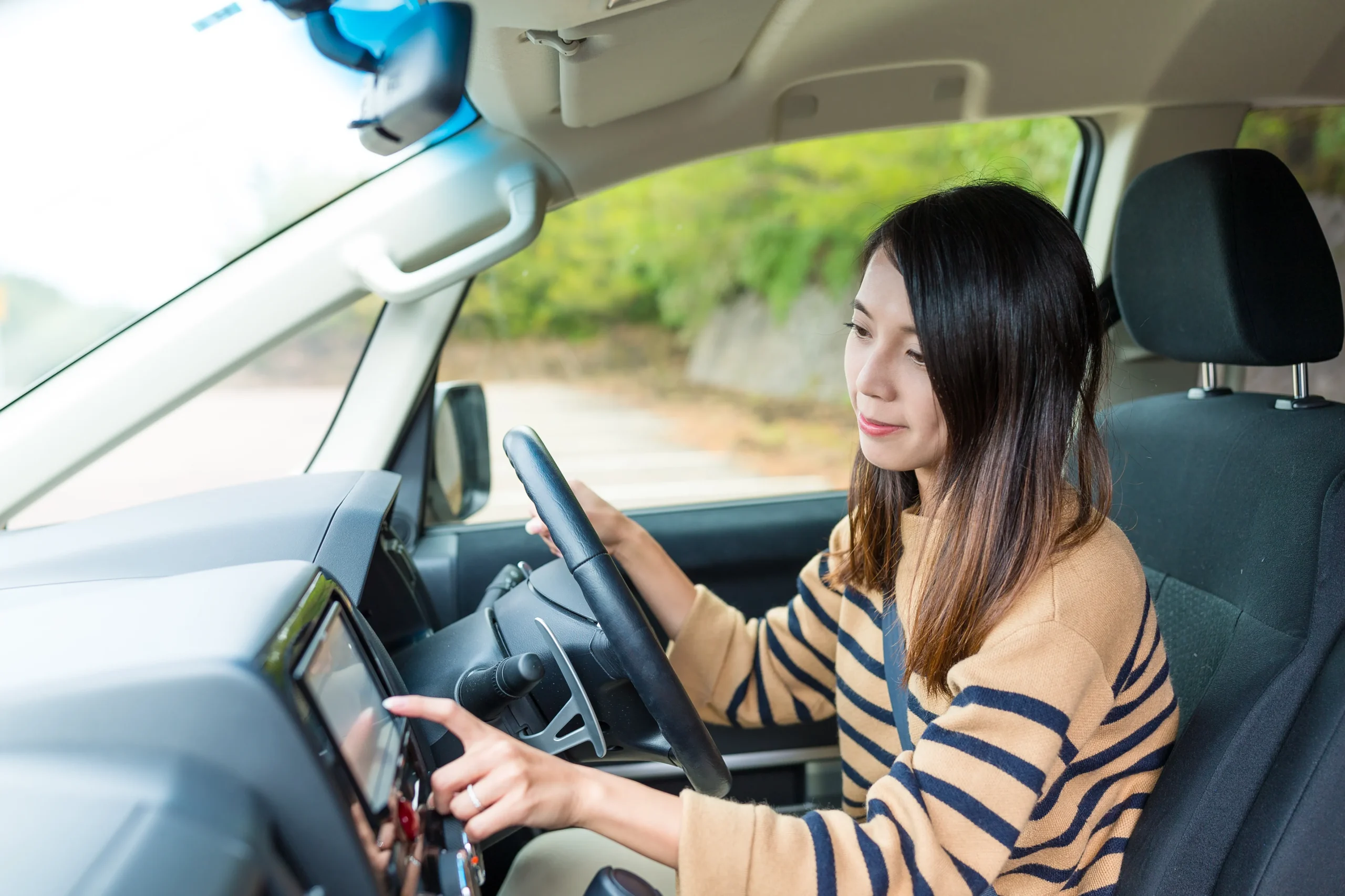 Page Hero image a woman putting her hand on steering of a luxury car